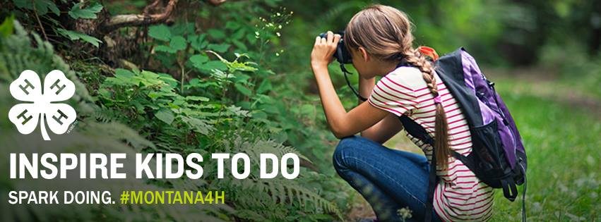 "Inspire kidst to do, Spark doing #MONTANA4H" with 4-H clover in lower left hand corner. A young girl with blonde braided hair, wearing a pink and white striped shirt, blue jean shorts, tall green socks, and a purple backpack is crouched holding a camera to her face focusing on a group of small green plants in the woods.